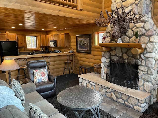 living area featuring rustic walls, a fireplace, wooden ceiling, and recessed lighting