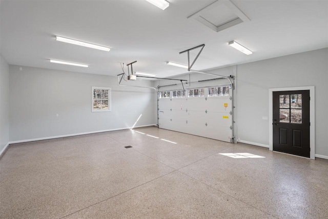 5975 Westward Psge, Harbor Springs, MI 49740 - garage with baseboards and a garage door opener
