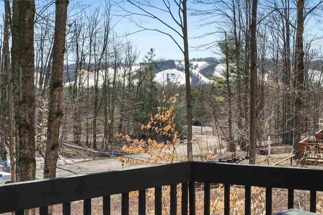 exterior space featuring a view of trees, a balcony, and a mountain view