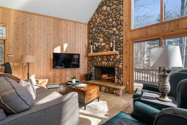 living area with a fireplace, wooden walls, high vaulted ceiling, and baseboard heating