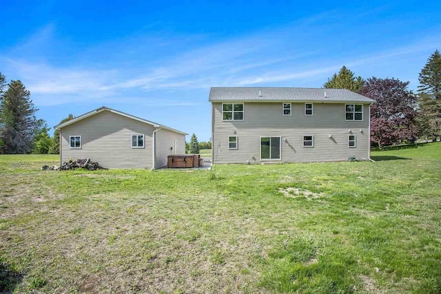 18180 Hilltop Dr, Charlevoix, MI 49720 - back of house featuring a hot tub and a yard