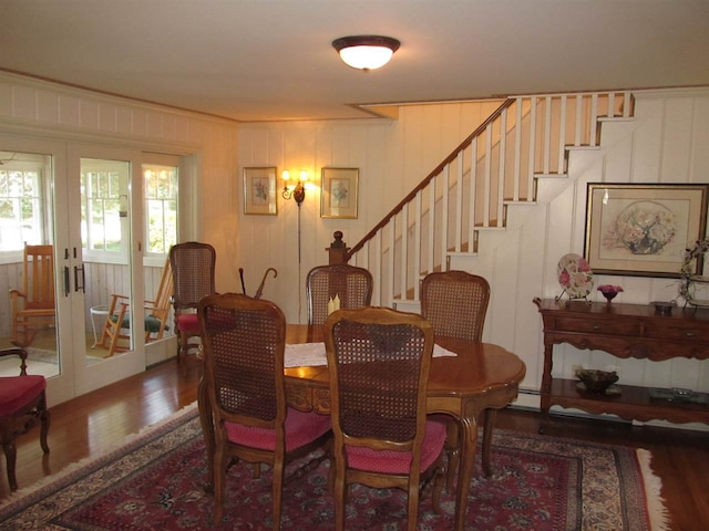 4251 Terpening Rd, Harbor Springs, MI 49740 - dining area with french doors, wood finished floors, stairs, and a baseboard radiator