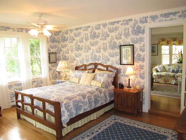4251 Terpening Rd, Harbor Springs, MI 49740 - bedroom with a ceiling fan, wood finished floors, and wallpapered walls