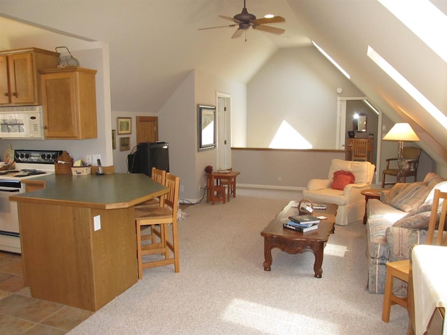 4251 Terpening Rd, Harbor Springs, MI 49740 - living area with vaulted ceiling, a ceiling fan, and light carpet
