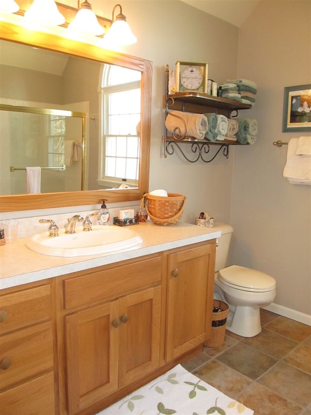 4251 Terpening Rd, Harbor Springs, MI 49740 - full bathroom featuring toilet, vanity, vaulted ceiling, and a stall shower