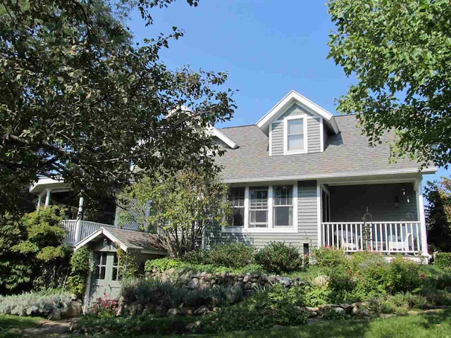 4251 Terpening Rd, Harbor Springs, MI 49740 - view of front of house featuring a porch and a shingled roof