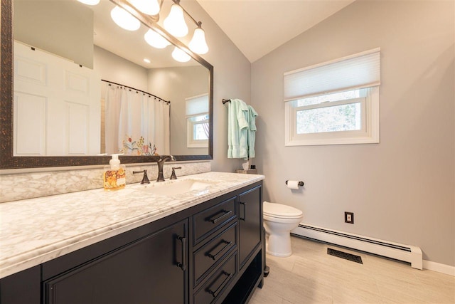 6001 N Silver Pines Dr, Bellaire, MI 49615 - full bath with lofted ceiling, baseboard heating, a wealth of natural light, and toilet