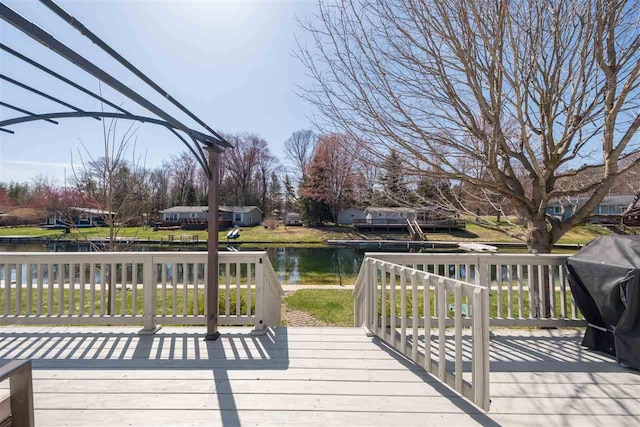 6001 N Silver Pines Dr, Bellaire, MI 49615 - wooden terrace with grilling area and a water view