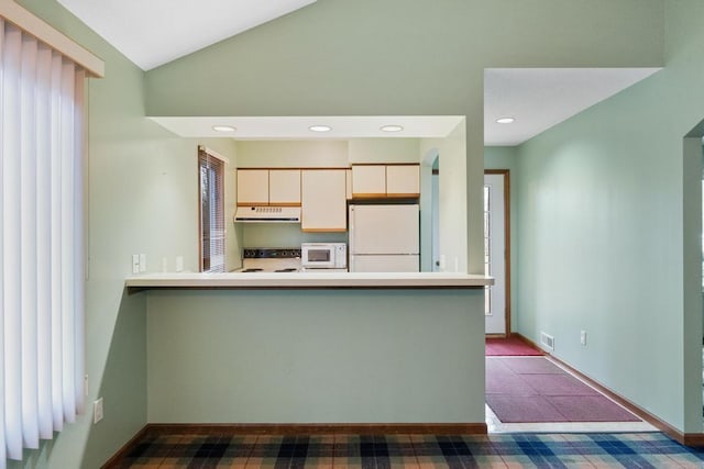 1871 Cherry Hill Ct, Harbor Springs, MI 49740 - kitchen with recessed lighting, under cabinet range hood, vaulted ceiling, white appliances, and a peninsula