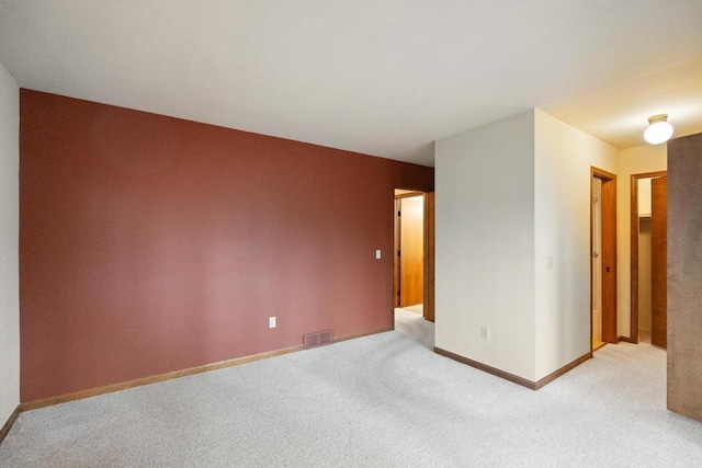 1871 Cherry Hill Ct, Harbor Springs, MI 49740 - unfurnished room featuring baseboards, visible vents, and light colored carpet