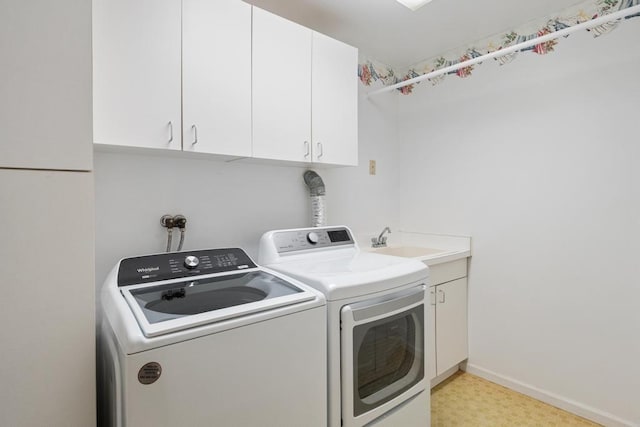 1871 Cherry Hill Ct, Harbor Springs, MI 49740 - laundry room featuring cabinet space, baseboards, a sink, and washer and clothes dryer