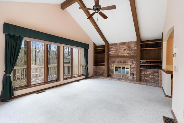 1871 Cherry Hill Ct, Harbor Springs, MI 49740 - unfurnished living room featuring a ceiling fan, arched walkways, carpet, a brick fireplace, and visible vents