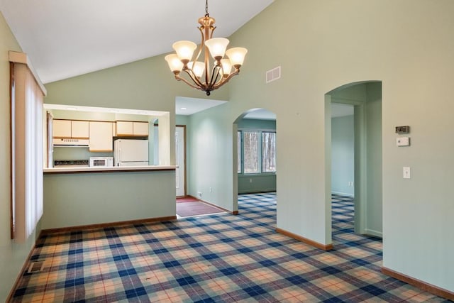 1871 Cherry Hill Ct, Harbor Springs, MI 49740 - kitchen featuring visible vents, white appliances, arched walkways, hanging light fixtures, and white cabinetry