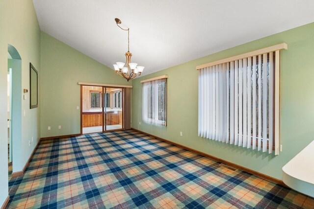 1871 Cherry Hill Ct, Harbor Springs, MI 49740 - carpeted empty room featuring baseboards, an inviting chandelier, and high vaulted ceiling