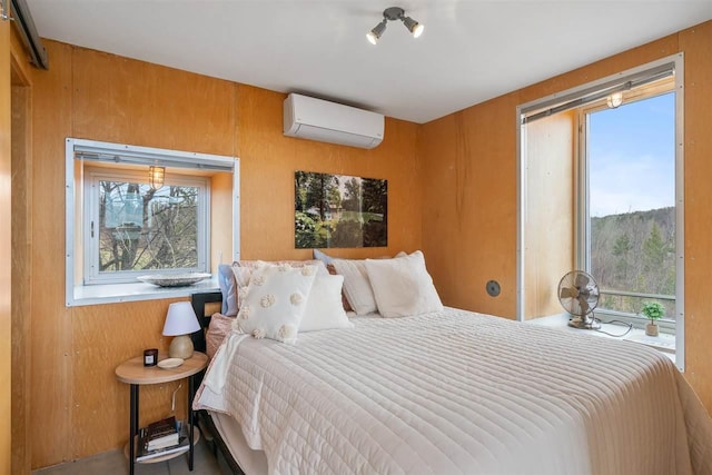 bedroom with a wall mounted air conditioner and multiple windows