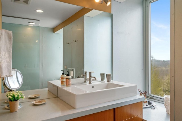 bathroom with vanity, visible vents, and recessed lighting