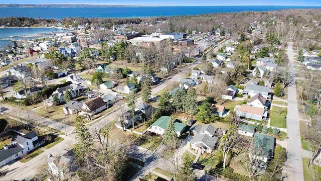 birds eye view of property with a water view and a residential view