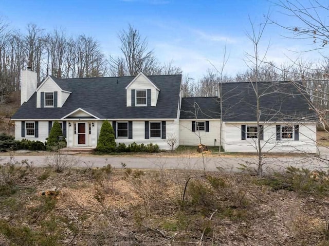 cape cod-style house with a chimney