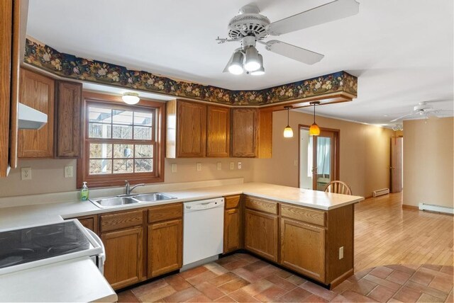 kitchen with under cabinet range hood, a ceiling fan, a sink, white appliances, and a peninsula