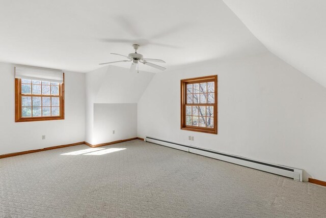 bonus room with lofted ceiling, carpet flooring, baseboard heating, and ceiling fan