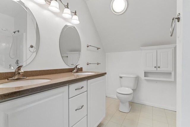 full bathroom featuring lofted ceiling, toilet, a sink, and visible vents