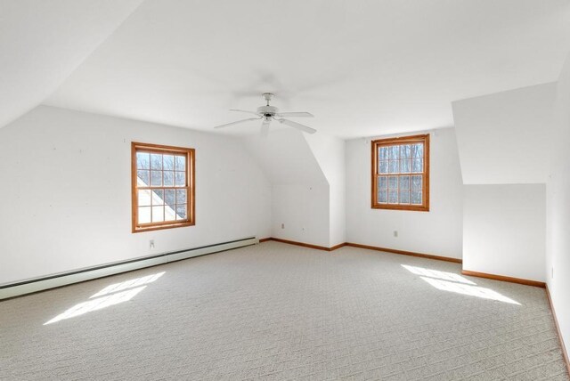 bonus room with baseboards, carpet, lofted ceiling, baseboard heating, and a ceiling fan