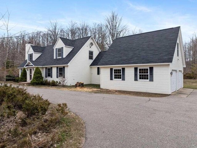cape cod house with a garage