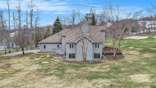 view of property exterior with roof with shingles and a yard