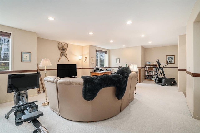 living area with recessed lighting, baseboards, and light carpet
