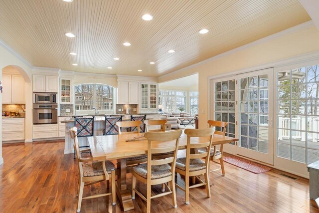 dining space with crown molding, recessed lighting, plenty of natural light, and visible vents