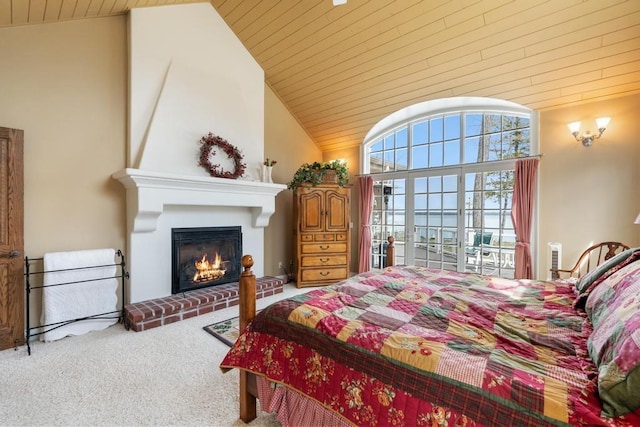 carpeted bedroom featuring wood ceiling, a water view, a fireplace, and high vaulted ceiling
