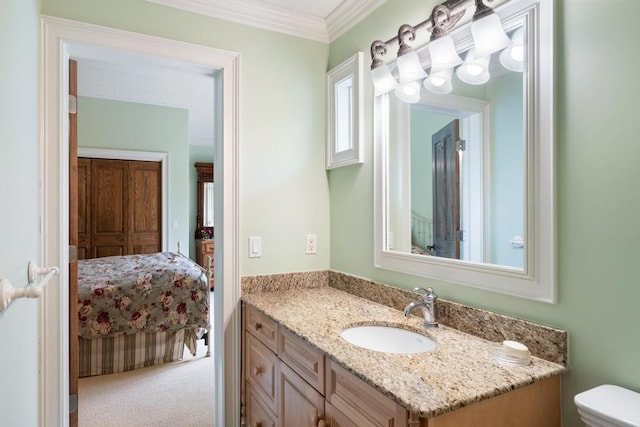 bathroom featuring vanity, ornamental molding, ensuite bathroom, and toilet