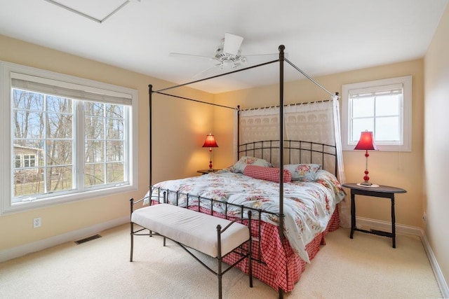 bedroom featuring visible vents, carpet flooring, baseboards, and a ceiling fan