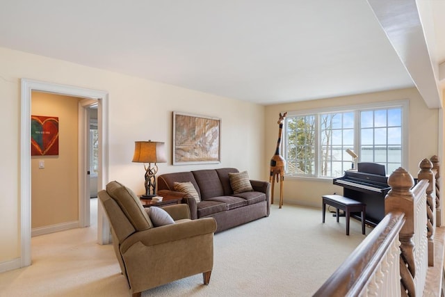 living room with baseboards and light colored carpet