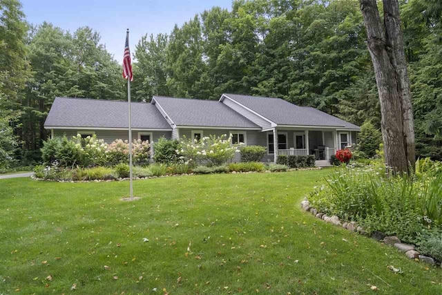 8913 Horseshoe Dr, Harbor Springs, MI 49740 - view of front of property with a porch and a front lawn