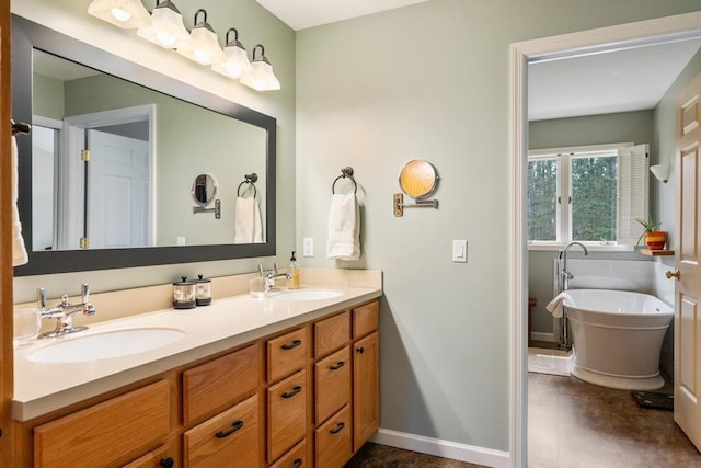 8913 Horseshoe Dr, Harbor Springs, MI 49740 - full bath with a soaking tub, baseboards, double vanity, and a sink