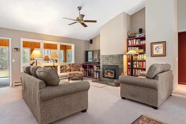 8913 Horseshoe Dr, Harbor Springs, MI 49740 - carpeted living area featuring a baseboard heating unit, a wood stove, high vaulted ceiling, a ceiling fan, and a baseboard radiator