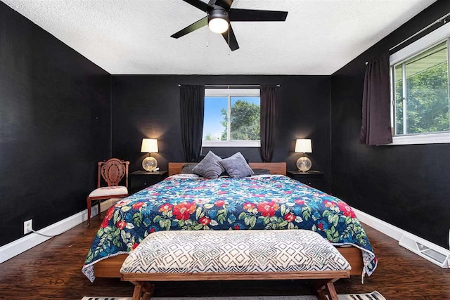 11601 Sequanota Heights Dr, Charlevoix, MI 49720 - bedroom with ceiling fan, visible vents, baseboards, a textured ceiling, and wood finished floors