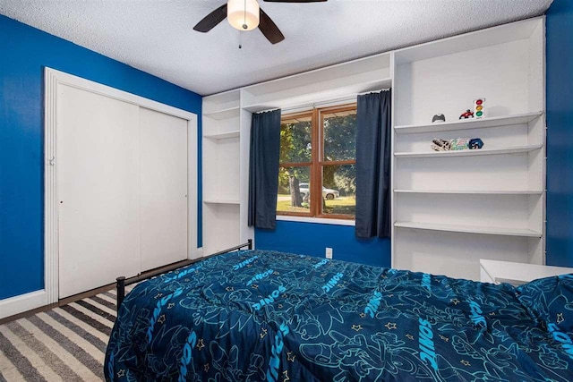 11601 Sequanota Heights Dr, Charlevoix, MI 49720 - bedroom with a ceiling fan, a closet, carpet, and a textured ceiling