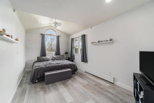 bedroom featuring baseboards, a baseboard heating unit, and wood finished floors