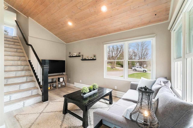 living room with lofted ceiling, wood finished floors, baseboards, stairway, and wood ceiling