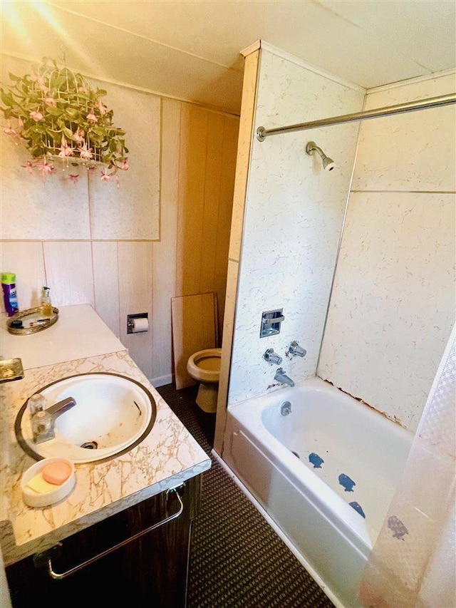 bathroom with vanity, tile patterned floors, washtub / shower combination, and toilet