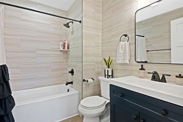 full bathroom with vanity, shower / bath combination with curtain, toilet, and tile walls