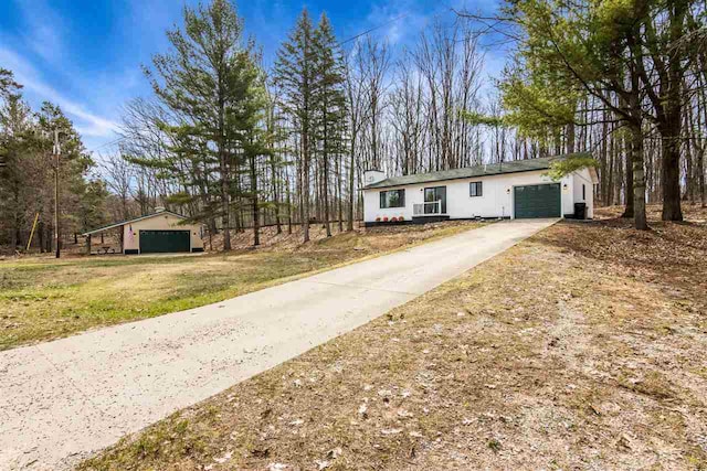 ranch-style home featuring an attached garage, driveway, and a front lawn