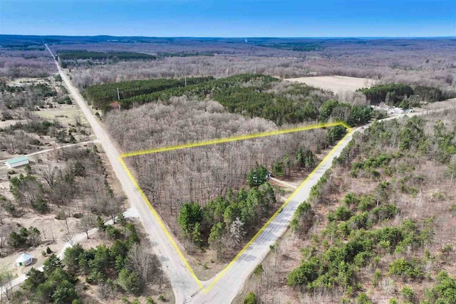 aerial view featuring a wooded view