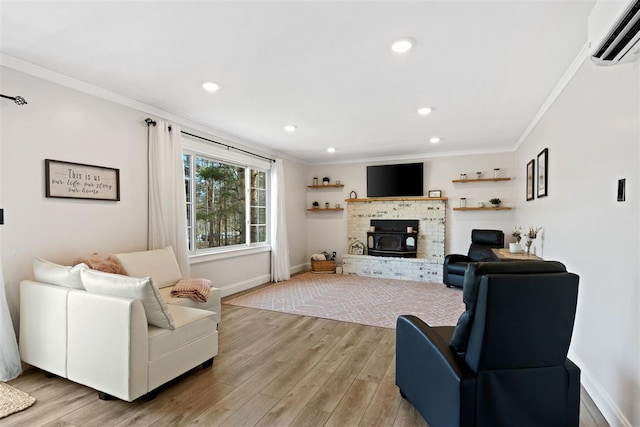 living room featuring crown molding, baseboards, recessed lighting, a wall mounted AC, and light wood finished floors