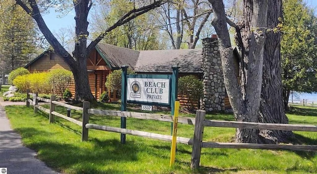 view of home's community with fence