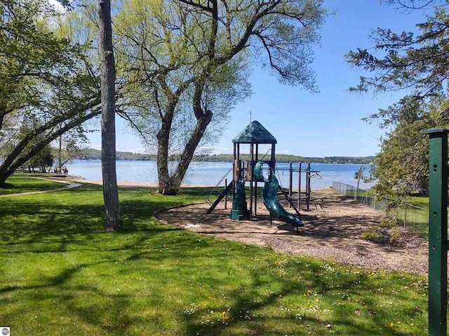 communal playground featuring a lawn and a water view