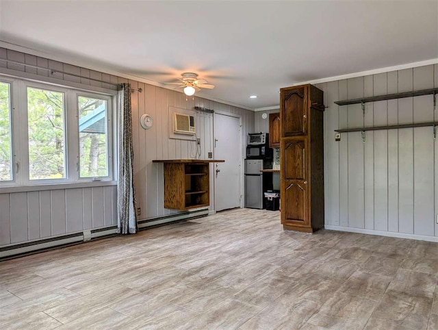 unfurnished living room with a wall unit AC, a ceiling fan, crown molding, light wood finished floors, and wooden walls