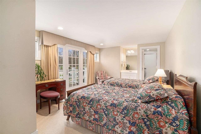 bedroom featuring ensuite bathroom and carpet